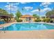 Refreshing community pool features clear blue water, ample deck space, and lush greenery in a serene setting at 2217 W Claremont St, Phoenix, AZ 85015