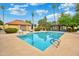 Sparkling community pool surrounded by lush palm trees, and plenty of space to lounge and relax at 2217 W Claremont St, Phoenix, AZ 85015