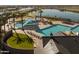 Aerial view showcasing the community pool, lake, shade structures, tables, and lounge chairs at 23162 E Canary Way, Queen Creek, AZ 85142