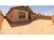 Unlandscaped backyard features privacy wall and covered patio at 23162 E Canary Way, Queen Creek, AZ 85142