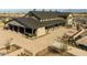 Spacious community building with covered patios, stone accents, and inviting outdoor seating areas at 23162 E Canary Way, Queen Creek, AZ 85142