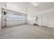 Spacious two car garage with epoxy floor, white walls and automatic door at 23162 E Canary Way, Queen Creek, AZ 85142