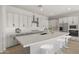 Bright kitchen featuring a large island, stainless steel appliances, and ample cabinet space at 23162 E Canary Way, Queen Creek, AZ 85142
