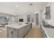 Open-concept kitchen with a large island, seamless flow into the adjacent living area and tv at 23162 E Canary Way, Queen Creek, AZ 85142