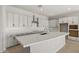 Bright kitchen with a large island, sleek countertops, and modern stainless steel vent hood at 23162 E Canary Way, Queen Creek, AZ 85142