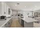 Spacious kitchen features white cabinets, large island with sink, and stainless steel appliances at 23162 E Canary Way, Queen Creek, AZ 85142
