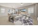 A beautifully staged living room and dining room area with lots of natural light and a ceiling fan at 23162 E Canary Way, Queen Creek, AZ 85142