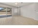 A spacious living room with lots of natural light, ceiling fan, and sliding glass door to patio at 23162 E Canary Way, Queen Creek, AZ 85142
