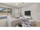 A beautifully staged living room with a ceiling fan, and sliding glass doors to a patio at 23162 E Canary Way, Queen Creek, AZ 85142