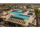 Stunning aerial view of the pool and recreation area with multiple pools, cabanas, and lounge chairs at 23163 E Canary Way, Queen Creek, AZ 85142