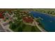 Beautiful aerial view of the community featuring a lake, clubhouse, walking paths, and other amenities at 23163 E Canary Way, Queen Creek, AZ 85142