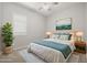 Comfortable bedroom featuring modern decor, a ceiling fan, and a cozy rug at 23163 E Canary Way, Queen Creek, AZ 85142