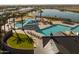 Aerial view of community pool area with pools, sun shades, lounge chairs, and well maintained landscaping at 23163 E Canary Way, Queen Creek, AZ 85142