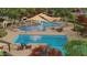 Stunning community pool area with a splash pad, ample seating, and shaded lounging spaces at 23163 E Canary Way, Queen Creek, AZ 85142