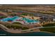 Aerial view of the community pool area, featuring multiple pools, seating, and shaded structures at 23163 E Canary Way, Queen Creek, AZ 85142