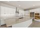 Bright open-concept kitchen featuring a large island, granite countertops, and white cabinetry at 23163 E Canary Way, Queen Creek, AZ 85142