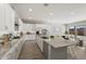 Spacious kitchen boasts an island, granite countertops, dining area, and flows into the living room at 23163 E Canary Way, Queen Creek, AZ 85142
