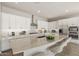 Modern kitchen boasts a large island, granite countertops, stainless steel appliances, and bar stool seating at 23163 E Canary Way, Queen Creek, AZ 85142