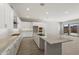 Spacious kitchen has an island, granite countertops, and seamlessly flows into the dining area at 23163 E Canary Way, Queen Creek, AZ 85142