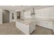 Well-designed kitchen includes a spacious island, granite counters, and white cabinets for storage at 23163 E Canary Way, Queen Creek, AZ 85142