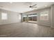 Bright living room with neutral walls, tile flooring, ceiling fan, modern light fixture and large windows at 23163 E Canary Way, Queen Creek, AZ 85142