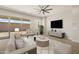 Staged living room featuring large couch, furniture, area rug, and slider door at 23163 E Canary Way, Queen Creek, AZ 85142