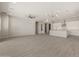 A spacious living room features tile floors and neutral-toned walls, flowing into the kitchen and dining areas at 23163 E Canary Way, Queen Creek, AZ 85142