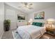 Bright main bedroom features a ceiling fan and neutral finishes at 23163 E Canary Way, Queen Creek, AZ 85142