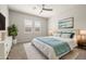Staged main bedroom with ceiling fan, carpet flooring, decor, and furnishings at 23163 E Canary Way, Queen Creek, AZ 85142