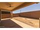 Covered patio area with ceiling fan, offering a comfortable outdoor space at 23163 E Canary Way, Queen Creek, AZ 85142