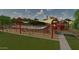A large playground with shade structures and benches surrounded by green space within the community at 23163 E Canary Way, Queen Creek, AZ 85142