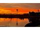 Sunset view of silhouette community and reflections over the water with a colorful sky at 23163 E Canary Way, Queen Creek, AZ 85142