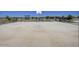 Basketball court with two benches, mountain views, and a covered playset in the distance at 24083 W Bowker St, Buckeye, AZ 85326