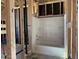 Unfinished bathroom featuring a new shower and tub insert surrounded by exposed wall studs and construction elements at 24083 W Bowker St, Buckeye, AZ 85326