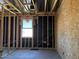 Framed bedroom featuring unfinished walls and a window showcasing the current stage of the construction process at 24083 W Bowker St, Buckeye, AZ 85326