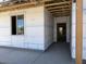 The entryway showcases the home's construction with an unfinished exterior and smooth concrete porch at 24083 W Bowker St, Buckeye, AZ 85326