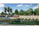 Well-maintained community entrance featuring lush landscaping and a welcoming stone sign, enhancing curb appeal at 2437 W Jessica Ln, Phoenix, AZ 85041