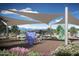 Community playground with mountain views and unique climbing features under a shade sail canopy at 2437 W Jessica Ln, Phoenix, AZ 85041