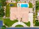 Aerial view of beige home with pool, spa, lush lawn, and well-maintained landscaping at 2505 E Lehi Rd # 16, Mesa, AZ 85213