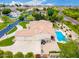 A rear view of a house, with a crystal clear pool and attached garage at 2505 E Lehi Rd # 16, Mesa, AZ 85213