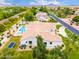 Aerial view of a home with a refreshing pool, spa, and lush green landscaping at 2505 E Lehi Rd # 16, Mesa, AZ 85213