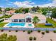 Aerial view of a house with a refreshing pool, spa, manicured backyard, and desert landscaping at 2505 E Lehi Rd # 16, Mesa, AZ 85213