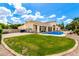 Spacious backyard with a pool, green lawn, and a beautiful home exterior at 2505 E Lehi Rd # 16, Mesa, AZ 85213