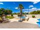 Serene backyard with a hot tub, lounge chair, and paved patio under a bright sky at 2505 E Lehi Rd # 16, Mesa, AZ 85213