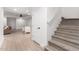 Spacious finished basement with light wood floors, stairs, and a ceiling fan at 2505 E Lehi Rd # 16, Mesa, AZ 85213