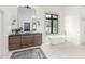 Bright bathroom featuring a modern vanity, freestanding tub, and large window, creating a spa-like experience at 2505 E Lehi Rd # 16, Mesa, AZ 85213
