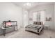 Neutral bedroom with light carpet, a bed with patterned throw, and a decorative terrarium at 2505 E Lehi Rd # 16, Mesa, AZ 85213