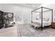 Airy bedroom with a four-poster bed, large windows, and cozy seating, creating a bright and inviting atmosphere at 2505 E Lehi Rd # 16, Mesa, AZ 85213