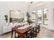 Sunlit dining area showcases an oversized wood table, and a large window framing views of the neighborhood at 2505 E Lehi Rd # 16, Mesa, AZ 85213