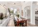 Formal dining room with large windows, modern chandelier, hardwood floors, and seating for ten at 2505 E Lehi Rd # 16, Mesa, AZ 85213